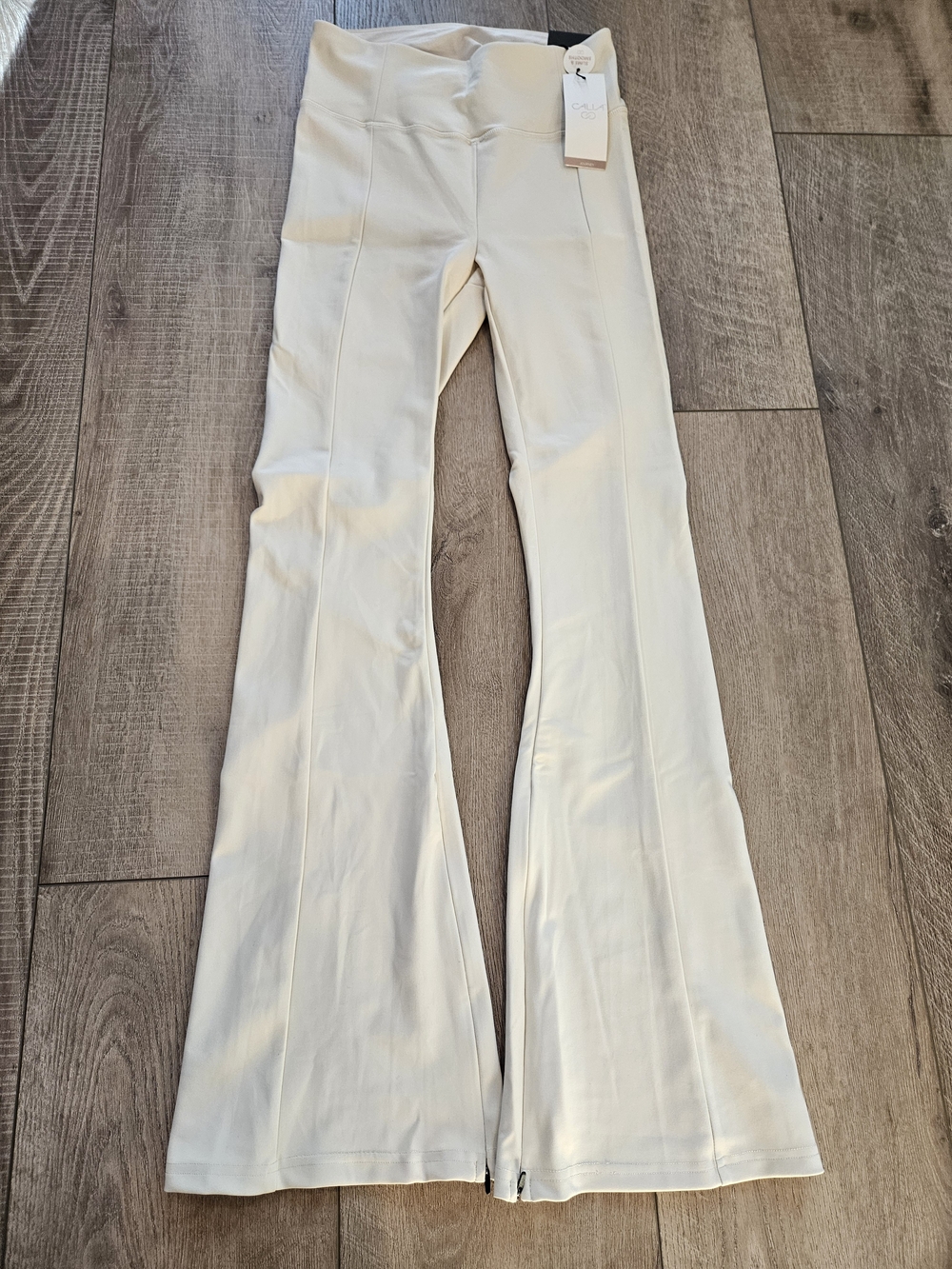 Calia High Rise Flare Leggings NWT Small Chantilly Cream Zip Hem